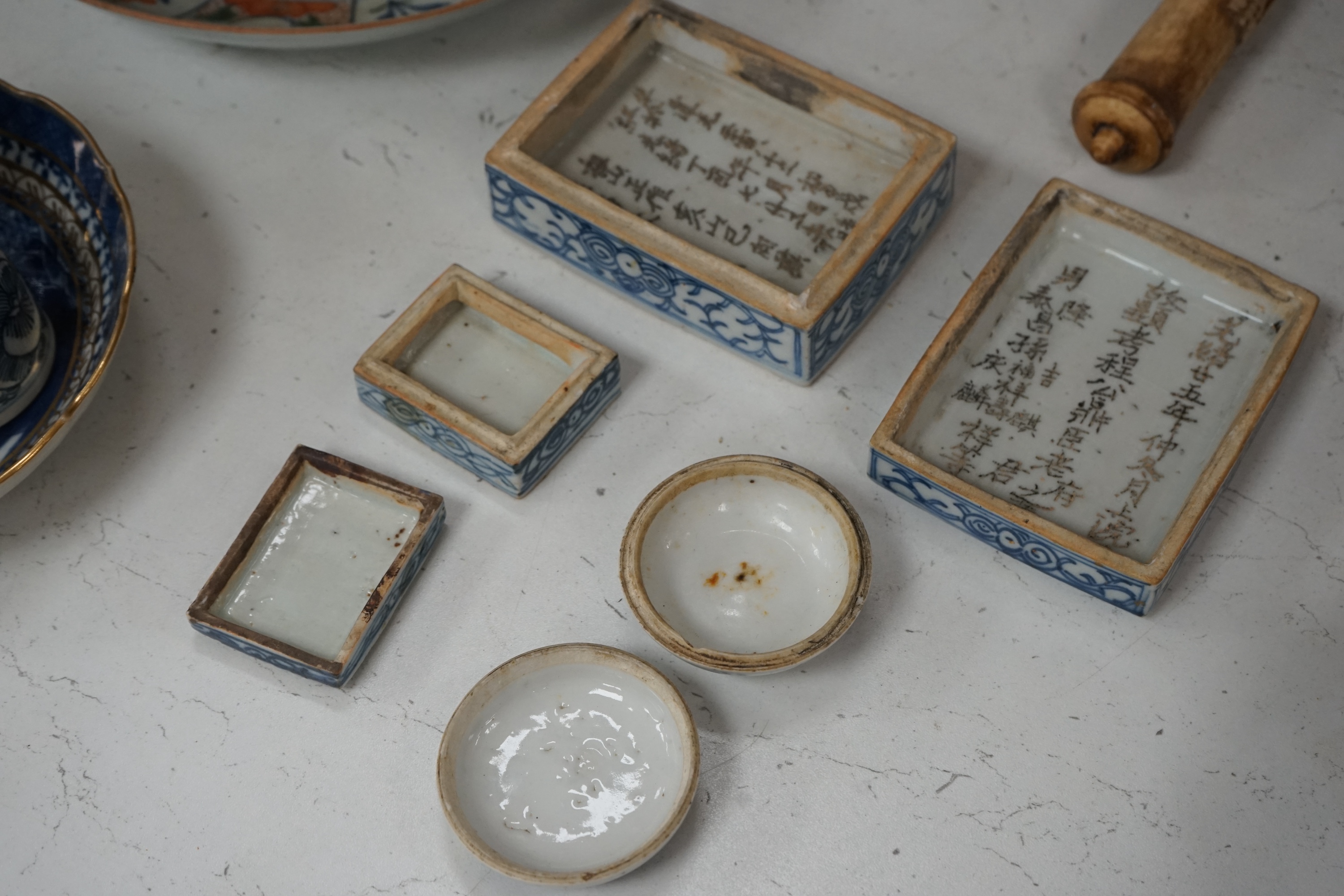 An 18th century Chinese export Imari pattern dish together with other Chinese blue and white ceramics, a hardwood stand and a bone calligraphy brush. Condition - varies